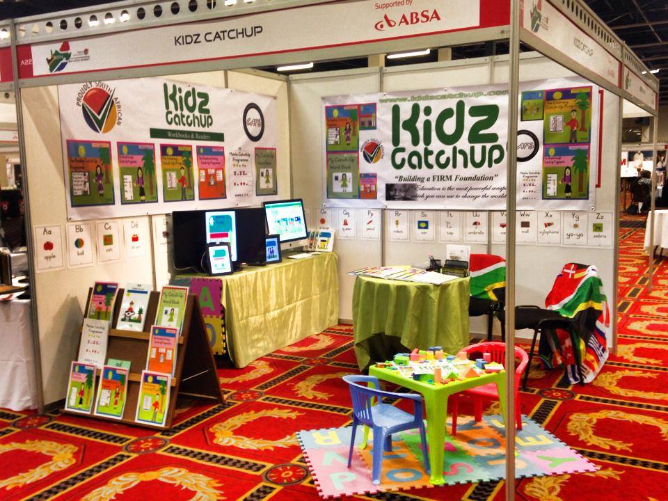 Kidscatchup workbooks and learning stations on display at an education exhibition